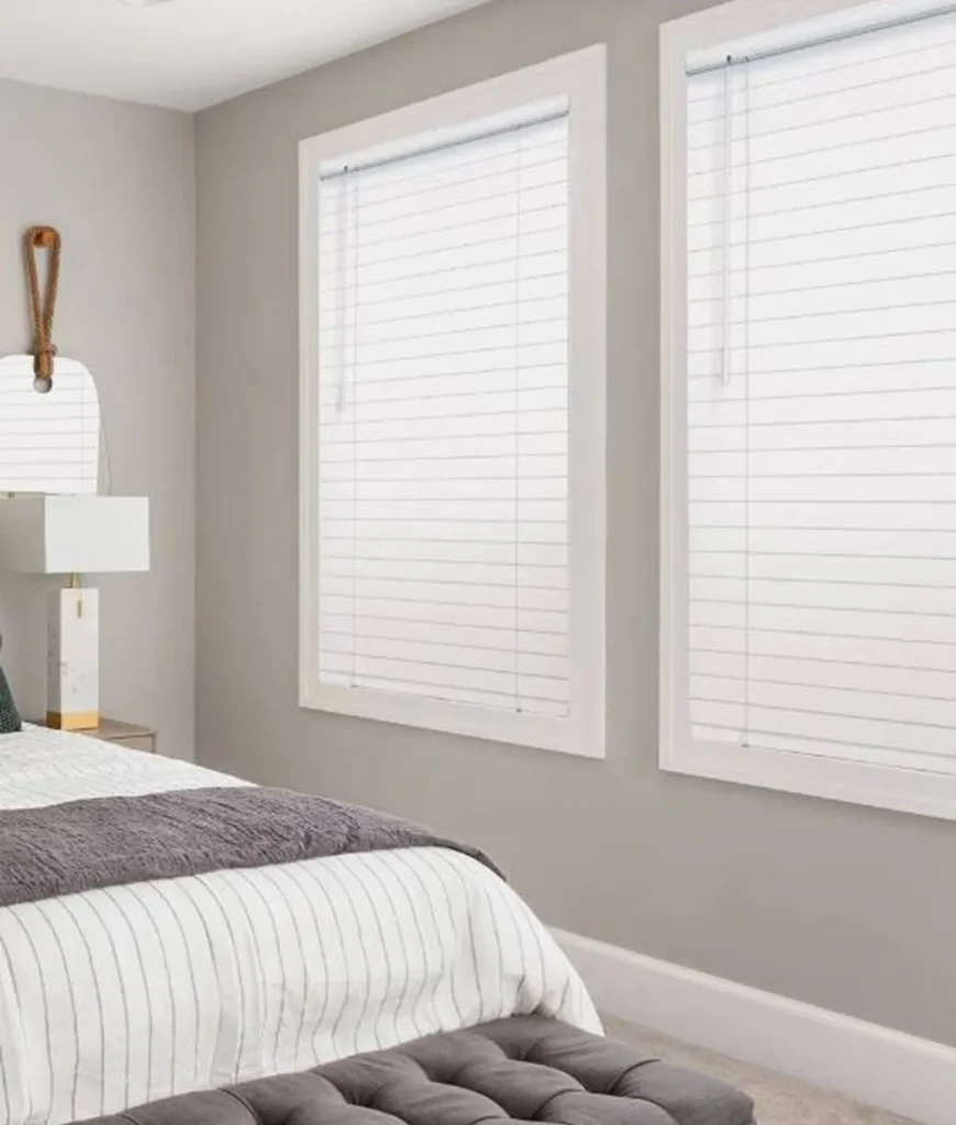Modern bedroom with striped bedding and blinds