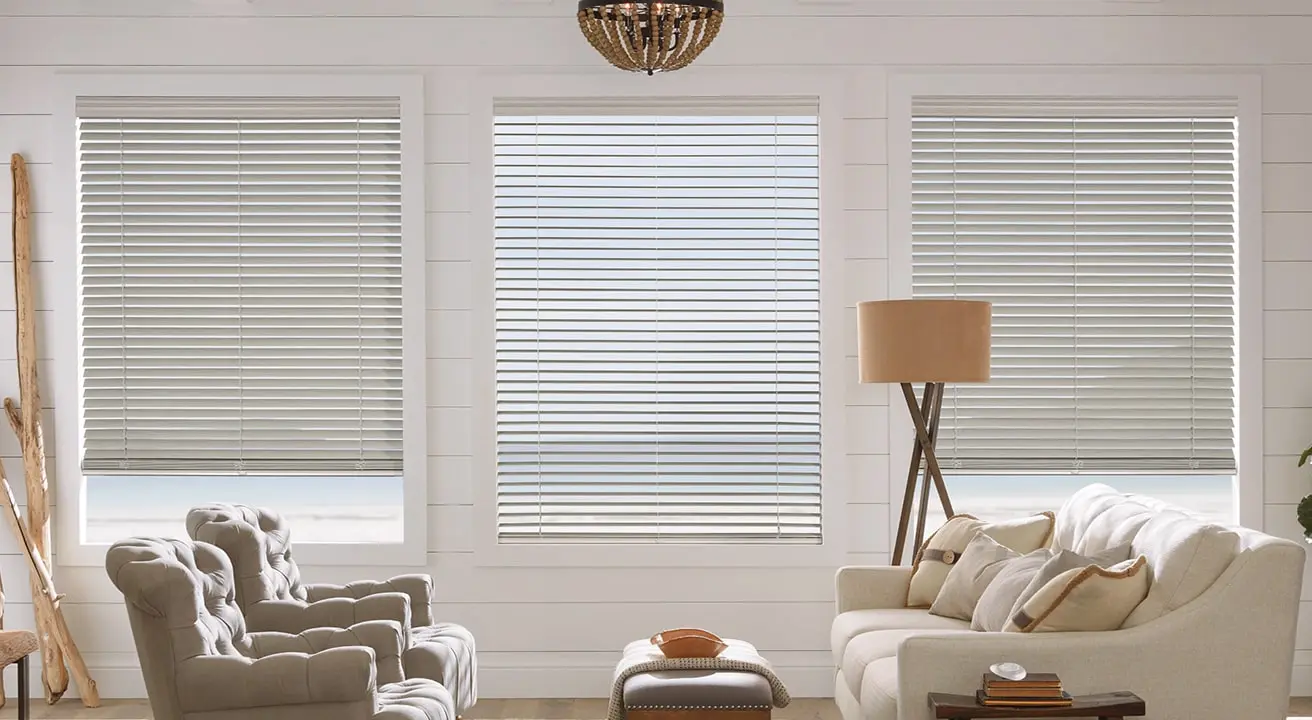 Cozy living room with blinds and comfortable seating.