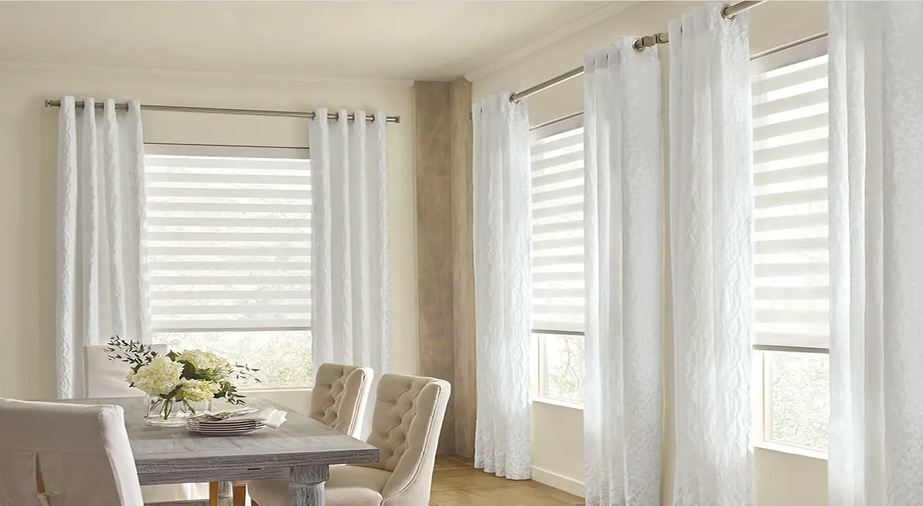 Dining room with sheer white curtains and flowers