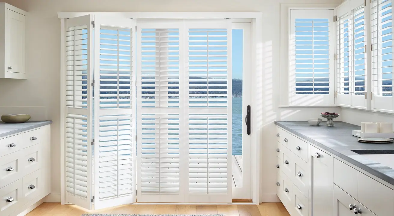Bright kitchen with shutters and ocean view.