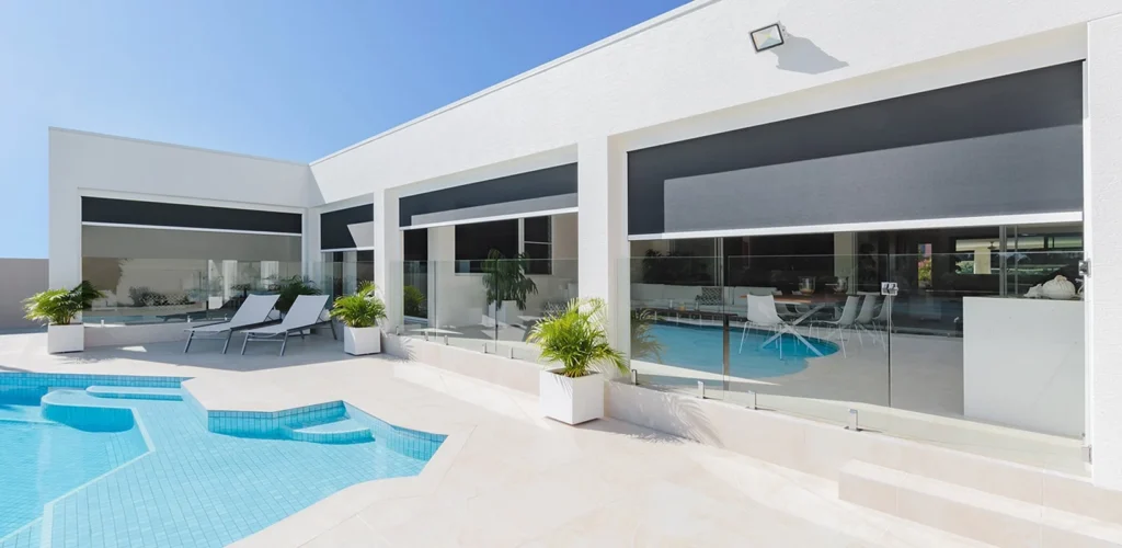 Modern patio with pool and lounge chairs.