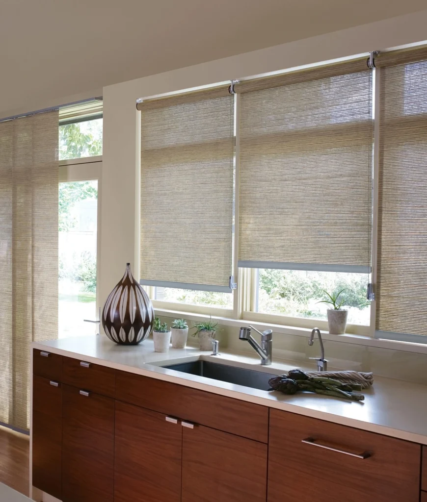 Modern kitchen sink with wooden cabinets and blinds.