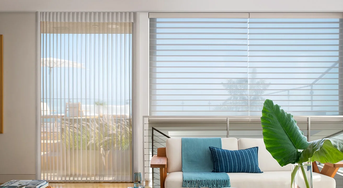 Living room with blinds and plant decor.