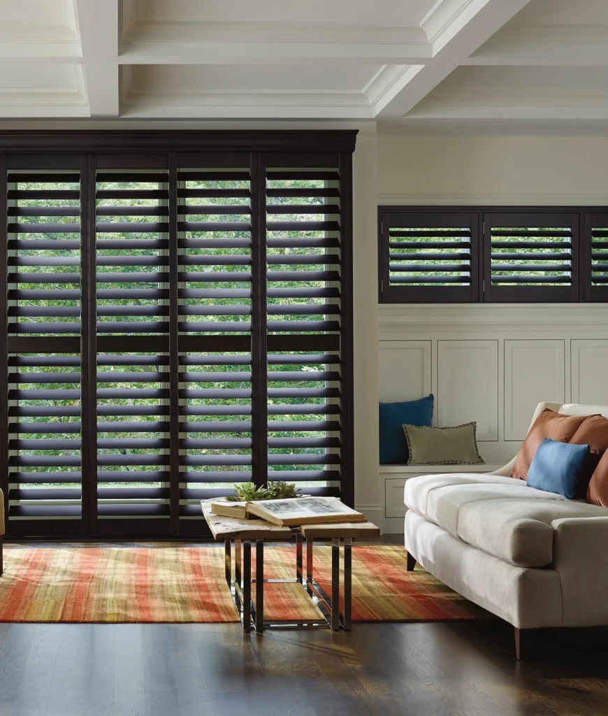 Modern living room with large window shutters.