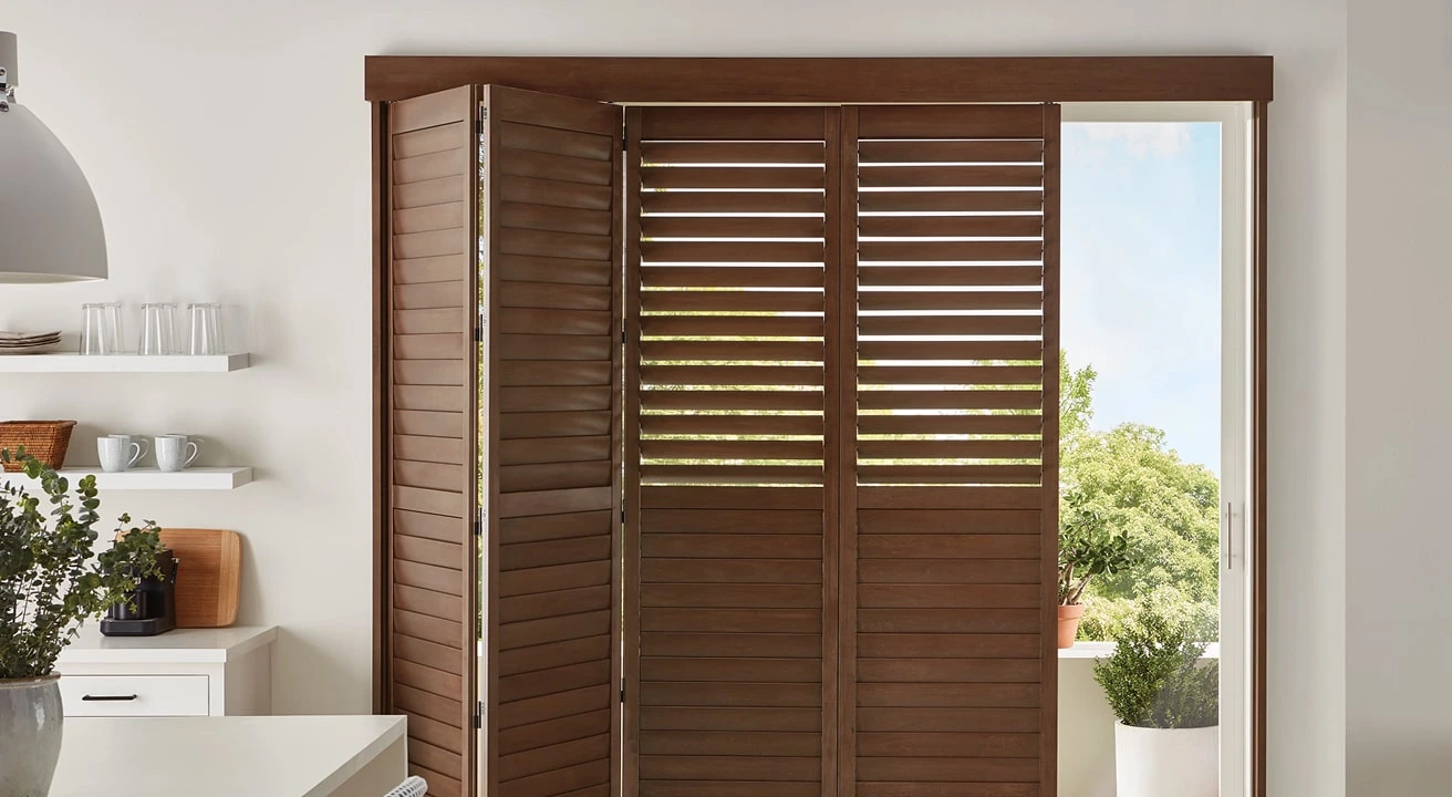 Wooden bi-fold shutters in modern kitchen.