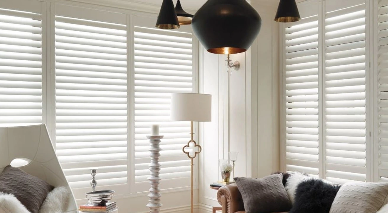Cozy living room with white window shutters.