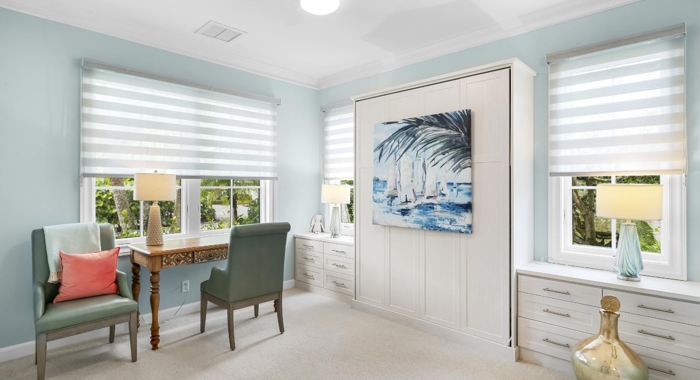 Elegant room with artwork, desk, and chairs