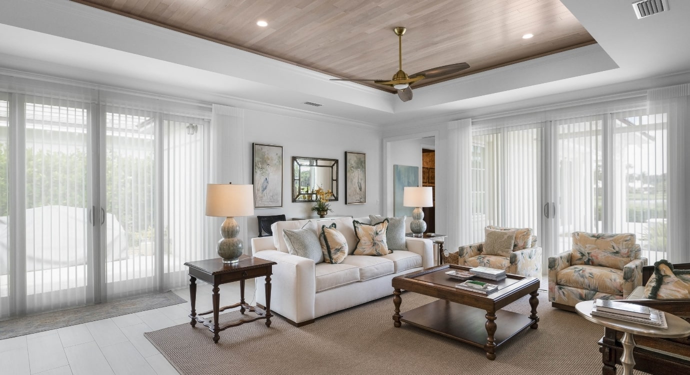 Elegant living room with modern decor and large windows.