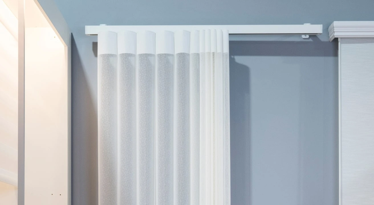 White vertical blinds on wall-mounted track